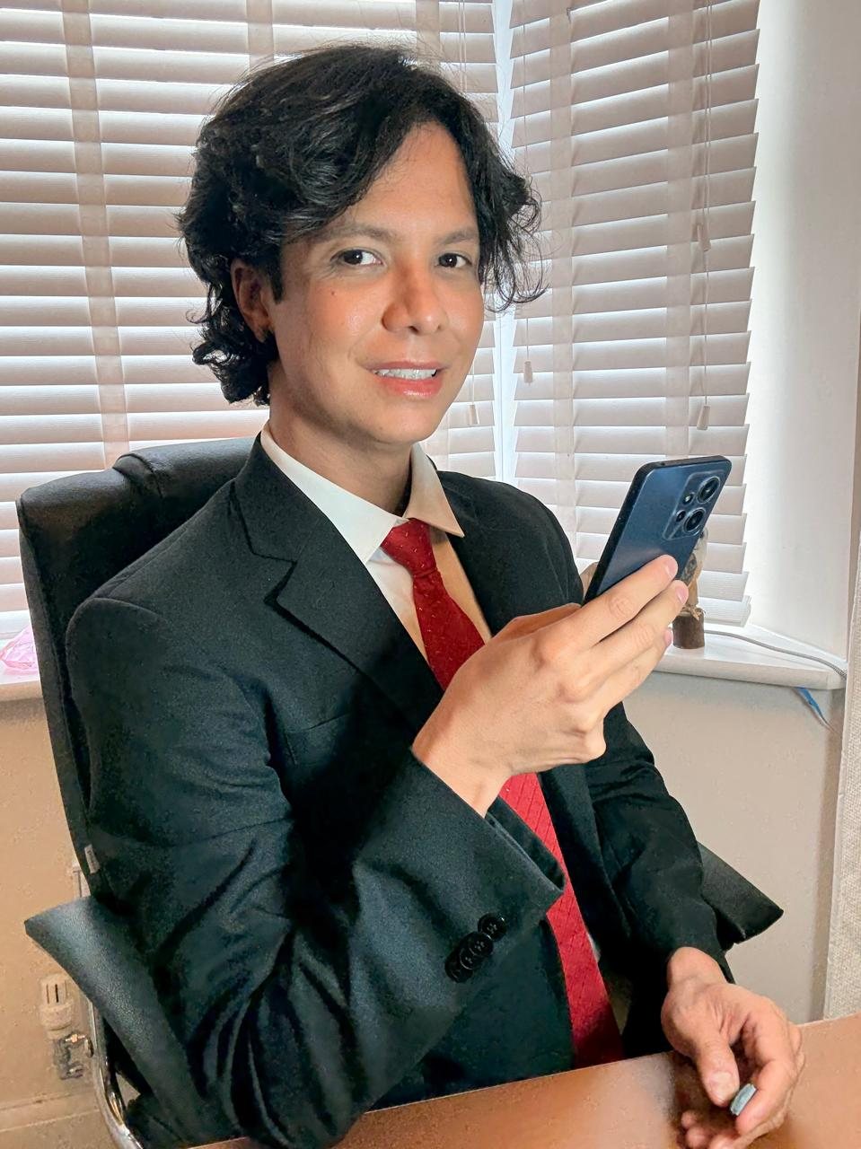 Thiago Opolski atendendo ao telefone, sorrindo